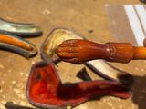 a wooden pipe and a pipe holder on a table