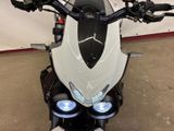 a close up of a motorcycle parked in a garage