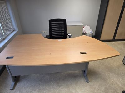 a desk with a chair in the corner of the room