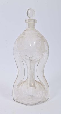 a clear glass bottle with a clear top on a white surface