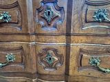 a wooden chest of drawers with many drawers on top of it