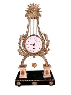 a clock that is sitting on a stand with a clock on it