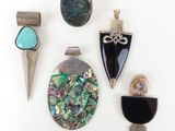 several different pieces of jewelry are displayed on a white surface