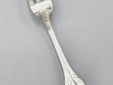 silver plated fork and spoon on a gray surface