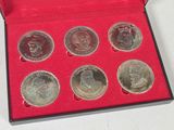a red box with six coins in it on a table