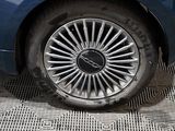 a close up of a tire on a blue car