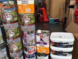 many cans of paint stacked on top of each other