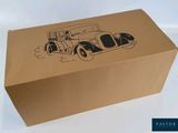 a cardboard box with a drawing of an old car on it