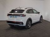 the rear end of a white volkswagen suv parked in a garage
