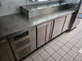 stainless steel counter top in a commercial kitchen with stainless steel appliances