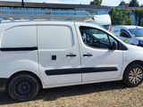 a white van parked in a parking lot next to other cars