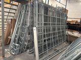 a large pile of metal frames in a warehouse