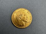 a close up of a gold coin on a black surface