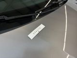 a sticker on the hood of a car with a name tag attached to it