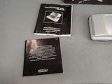 three electronic devices sitting on a table next to each other
