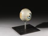 une photo d'une sculpture représentant un globe oculaire posé sur un socle
