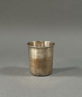 a silver cup that is sitting on a table