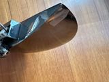 a close up of a motorcycle mirror on a wooden table