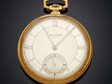 an old gold pocket watch with roman numerals and roman numerals on the face