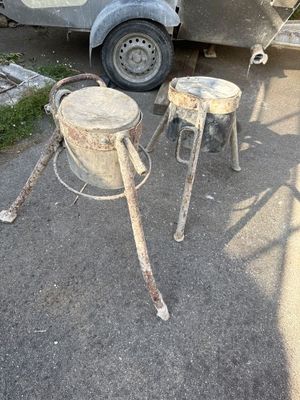 two old metal stools sitting next to a camper
