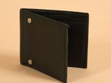 a black leather wallet with a metal button on the front