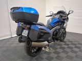 a blue and black motorcycle parked in a garage