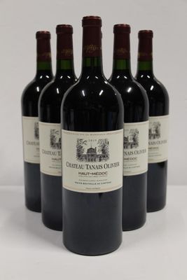 four bottles of red wine are lined up on a white surface