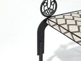 a black and white bench with wheels on top of it