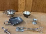a table with a variety of kitchen utensils on it