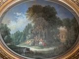 a painting on the wall of a room with a painting of a man and a woman