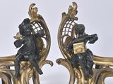 pair of antique bronze figurines of a man and a woman on a bench