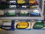 many different types of toy trucks in a display case