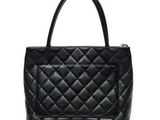 a black leather handbag with a zipper closure on the front