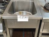 a stainless steel sink in the middle of a kitchen