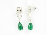 a pair of green jade and diamond earrings on a white background