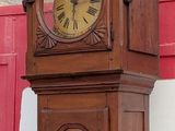 a grandfather clock that is on the side of a building