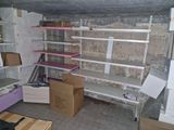 a room with shelves and boxes on the floor