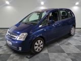 a picture of a small blue car parked in a garage