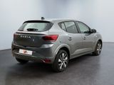 the rear of a silver car is parked in a room