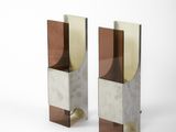 two metal and glass bookends on a white surface