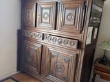 a large wooden cabinet in the corner of a room