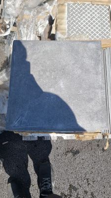 a man holding a large piece of metal in his hands