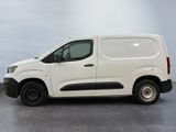 the white van is parked on the concrete floor in the room