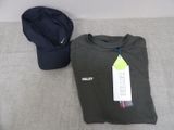 a hat and a t - shirt sitting on a bed