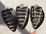 two pairs of black and chrome shoes are sitting on a concrete surface