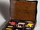 a wooden box with a variety of teas inside of it