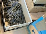a box of train tracks sitting on a table next to a box of boxes