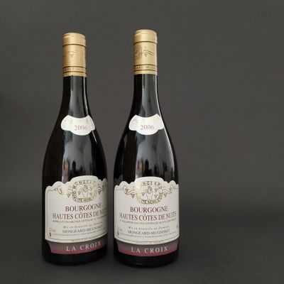 two bottles of wine sitting next to each other on a table