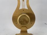 an image of a golden clock on a marble base