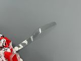 a person holding a knife with a red and white design on it